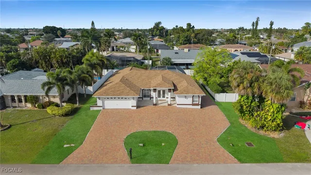 an aerial view of a house with yard swimming pool and outdoor seating