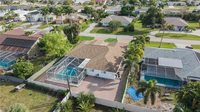 an aerial view of a house with a yard basket ball court and outdoor seating