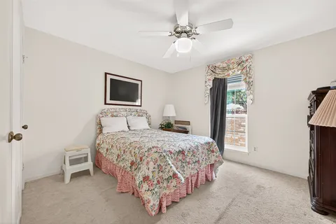 a bedroom with bed and a chandelier