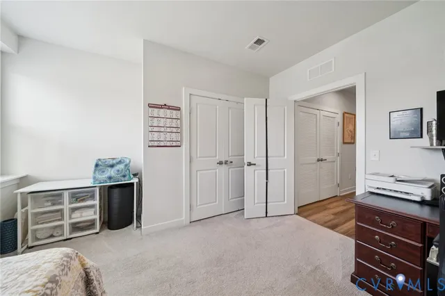 a bedroom with a bed and a desk