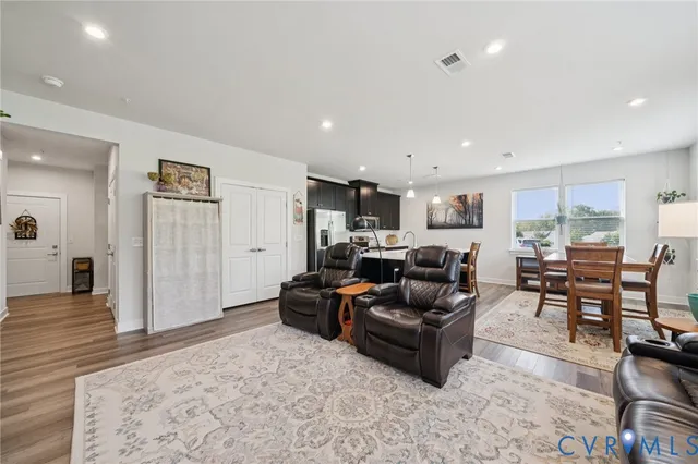 a living room with furniture and a wooden floor