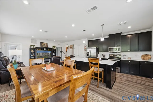 a dining room with furniture a rug and wooden floor