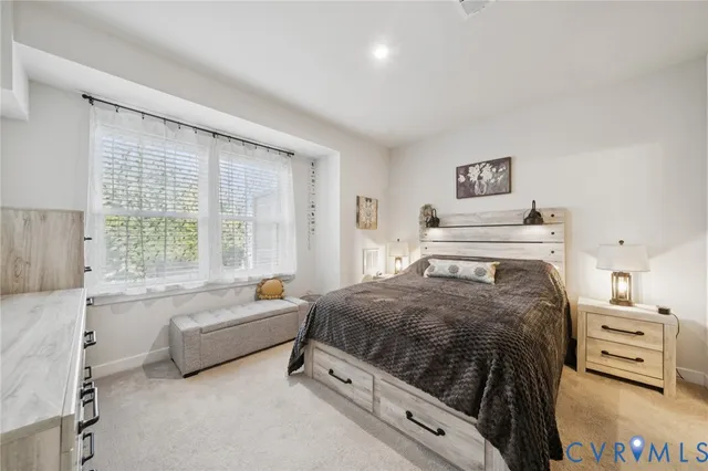 a kitchen with stainless steel appliances kitchen island granite countertop a table chairs and a refrigerator