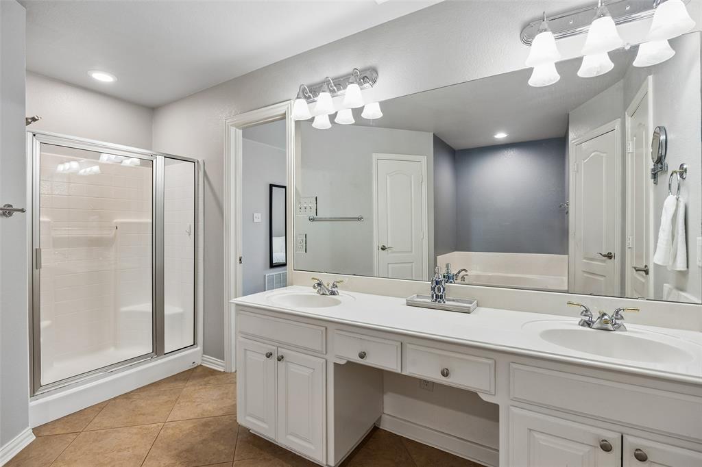 11211 Emerald Ranch Lane Forney, TX 75126 - Photo 26 of 35 Primary Bathroom featuring a dual-sink vanity with white cabinetry, a large frameless mirror, and overhead vanity lighting
