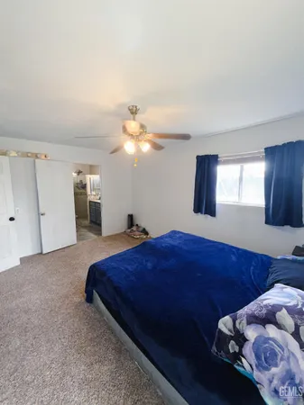 a bedroom with bed and window