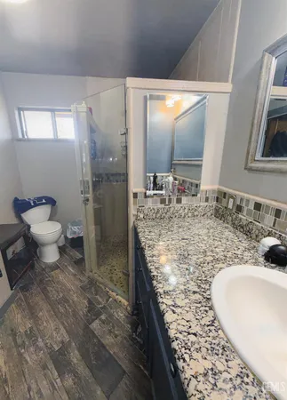 a bathroom with a sink a toilet and shower curtain