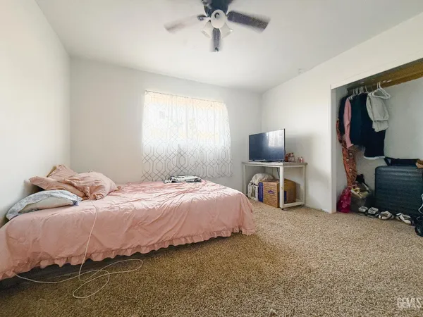 a bed room with a bed and a chandelier