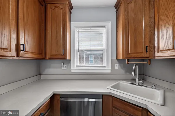 a kitchen with stainless steel appliances granite countertop white cabinets and a sink