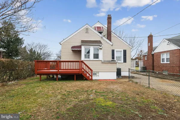 a view of a house with a yard and sitting area