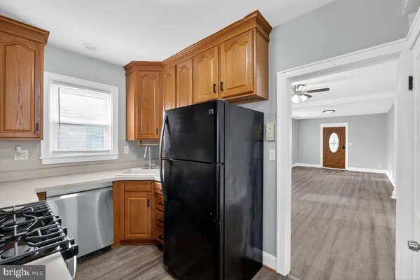 a kitchen with a refrigerator and a sink