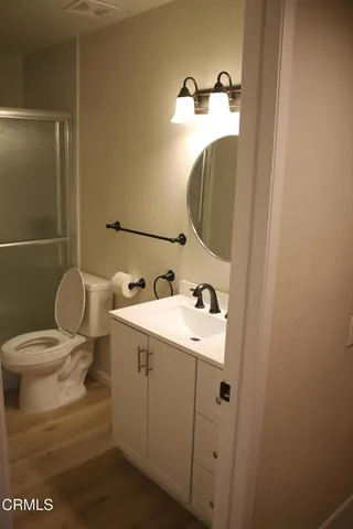 a bathroom with a toilet and a shower