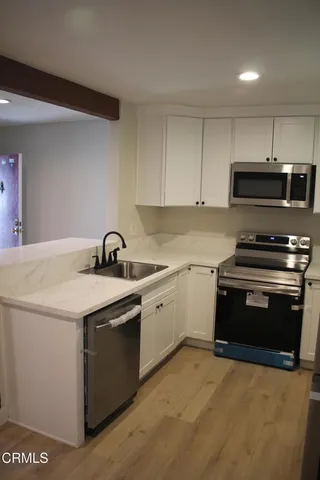 a kitchen with stainless steel appliances granite countertop a stove and a sink