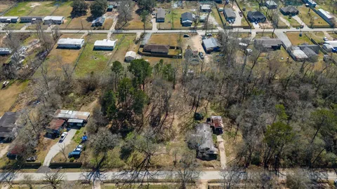 an aerial view of a houses with a yard