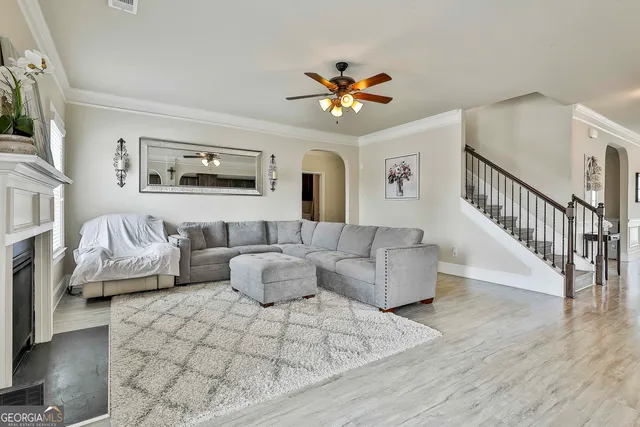 a living room with furniture a fireplace and a window