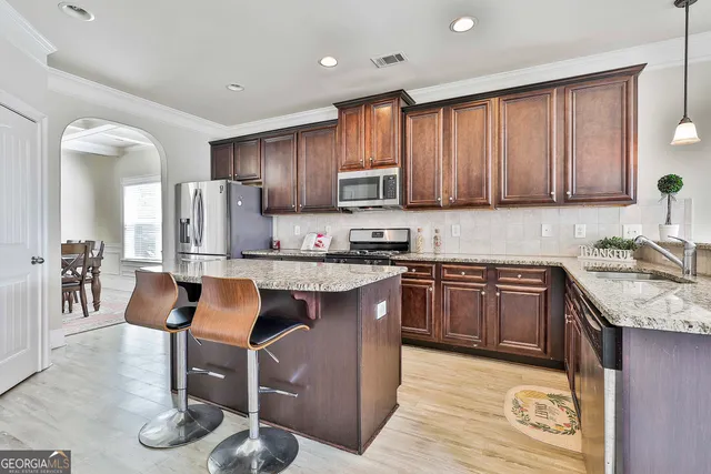 a kitchen with sink and cabinets