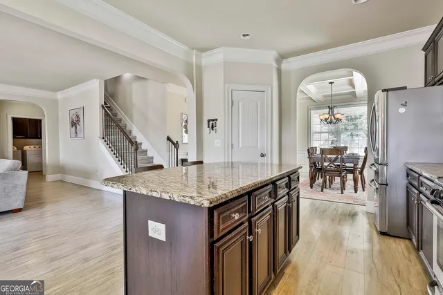 a dining room with furniture and a chandelier