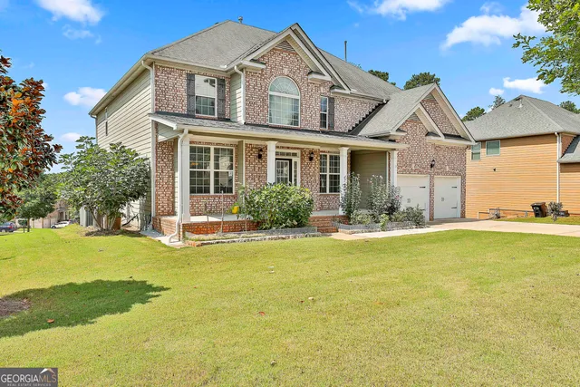 a front view of house with yard and swimming pool