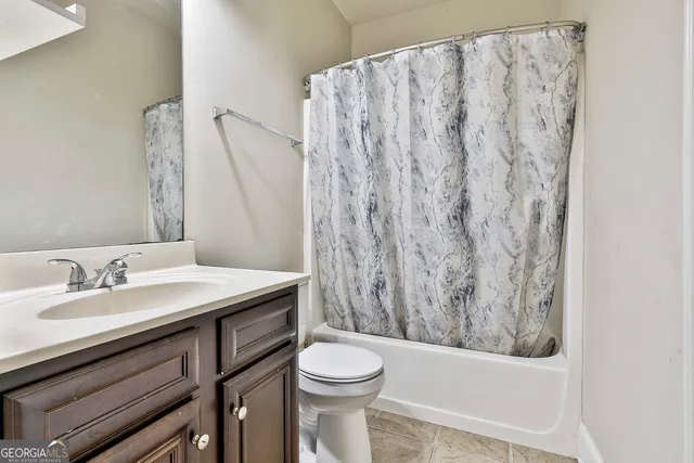 a view of a hallway with wooden floor and closet
