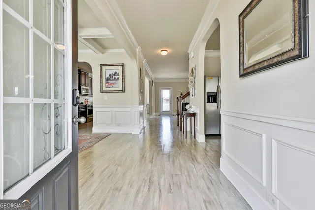 a view of a hallway view with wooden floor and staircase