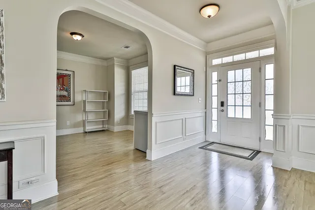 a view of an empty room with a wooden floor and a window