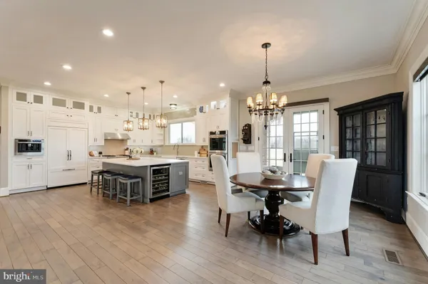 a view of a dining room with furniture and chandelier