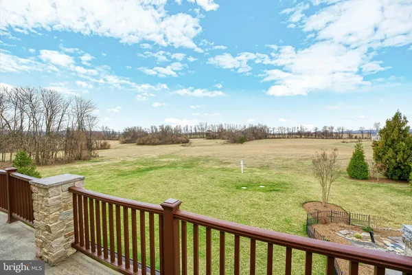 a bedroom with a bed and a flat tv screen on dresser