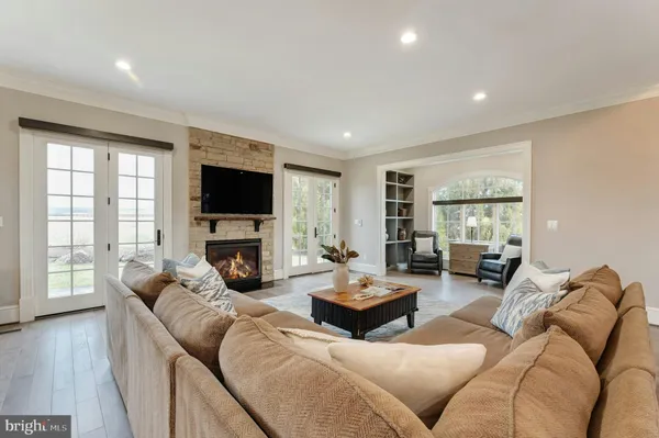 a living room with furniture a fireplace and a flat screen tv