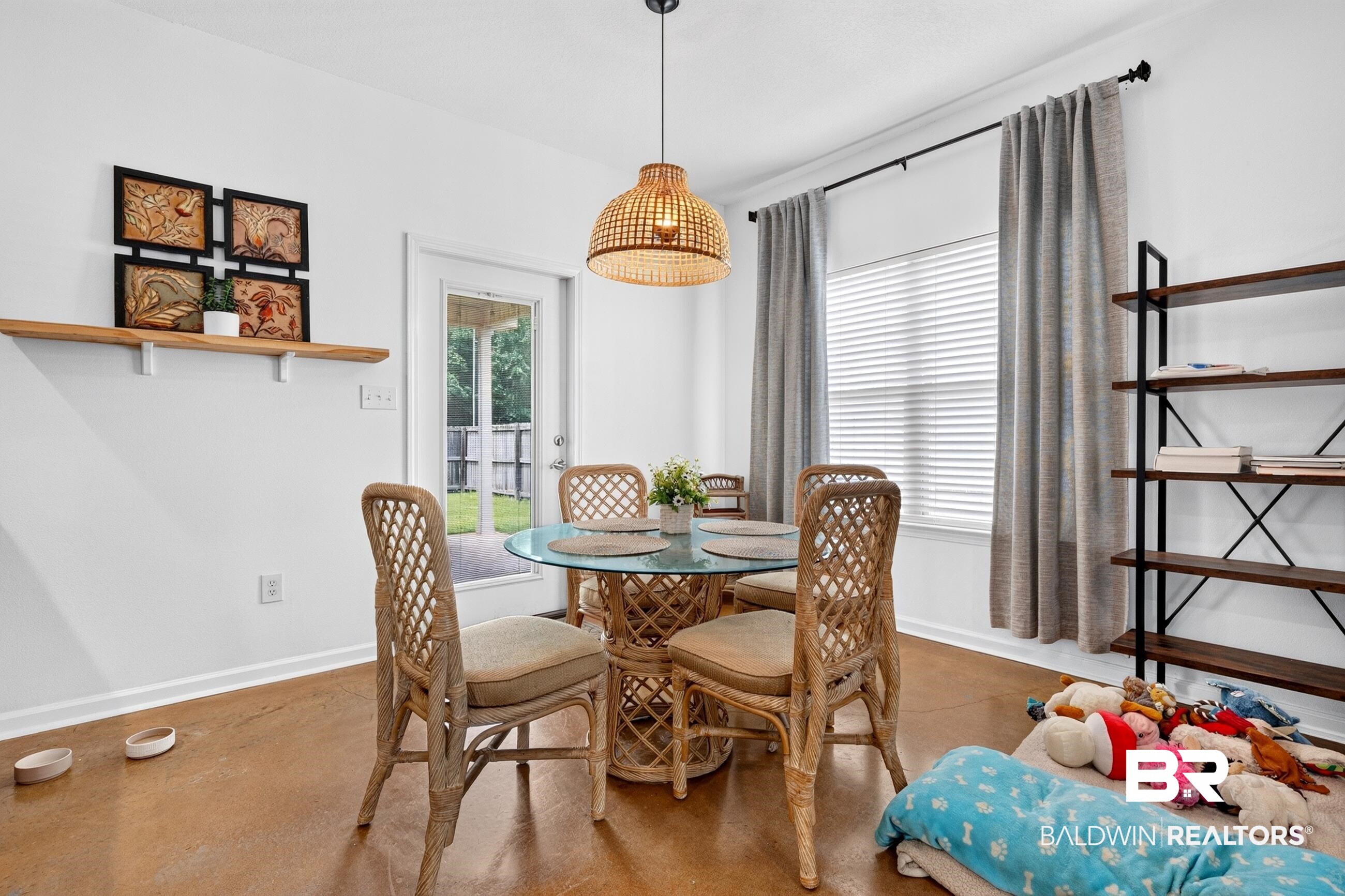 17419 Lewis Smith Drive Foley, AL 36535 - Photo 10 of 38 Bright dining area featuring a glass-top table, woven pendant lighting, and direct access to an outdoor space