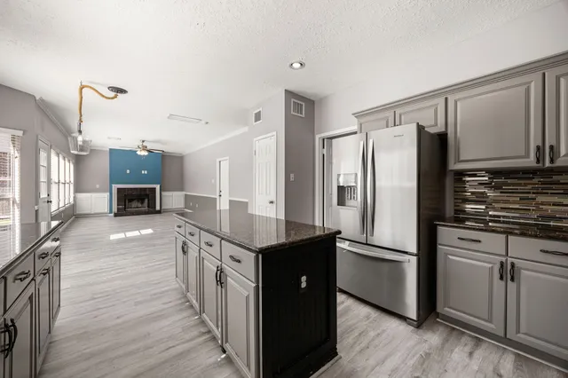 a kitchen with stainless steel appliances a refrigerator and a stove top oven