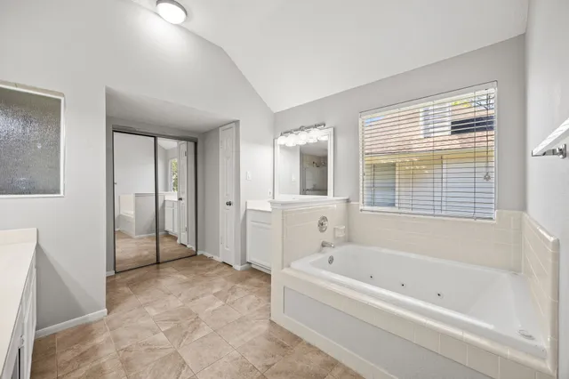 a spacious bathroom with a bathtub and a shower