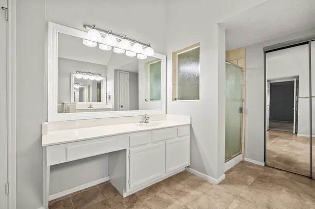 a bathroom with a double vanity sink mirror and