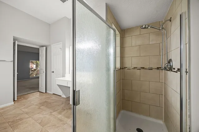 a bathroom with a shower and a tub