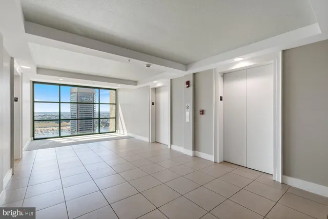 a view of staircase with white walls and a window