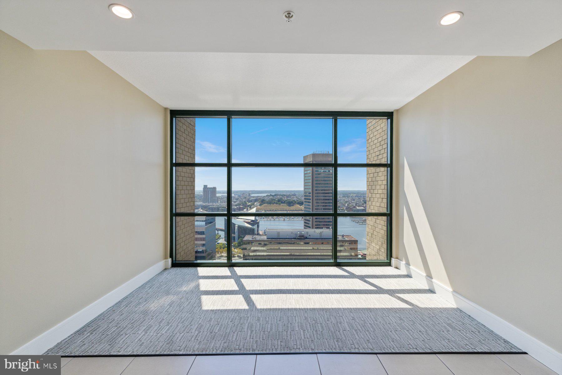 414 Water Street, Unit 2512 Baltimore, MD 21202 - Photo 29 of 40 a view of staircase with white walls and a window
