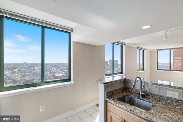 a kitchen with stainless steel appliances granite countertop a sink a stove and a refrigerator