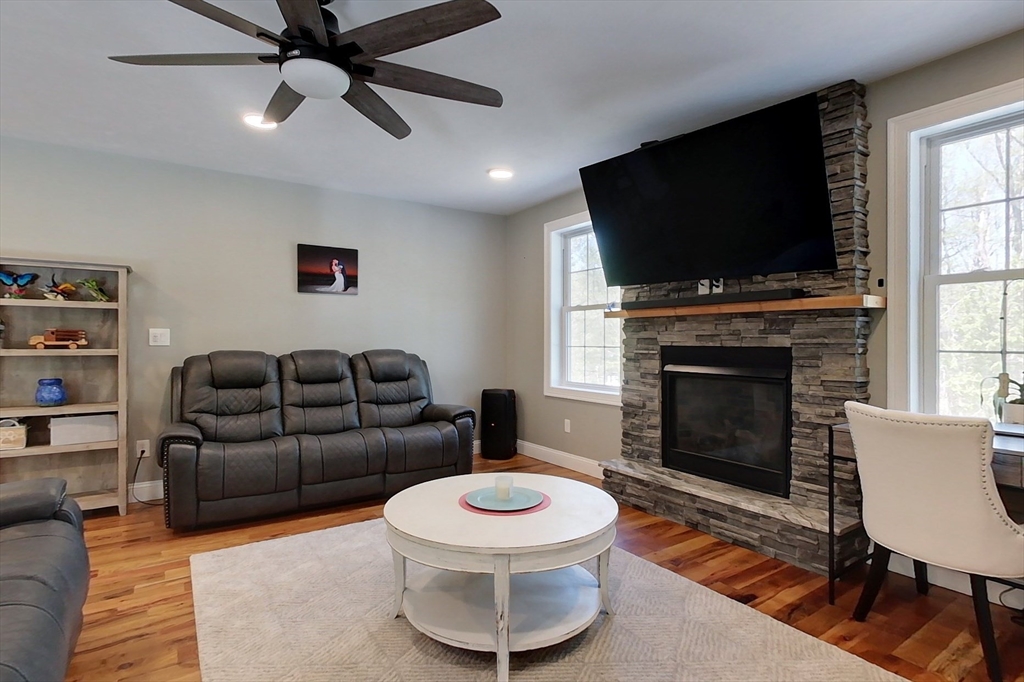 45 Secret Lake Road Phillipston, MA 01331 - Photo 13 of 42 a living room with furniture a flat screen tv and a fireplace