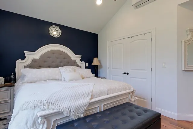 a bedroom with a bed and a table