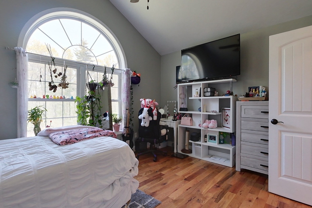 45 Secret Lake Road Phillipston, MA 01331 - Photo 20 of 42 a bedroom with a bed a flat screen tv and a large window