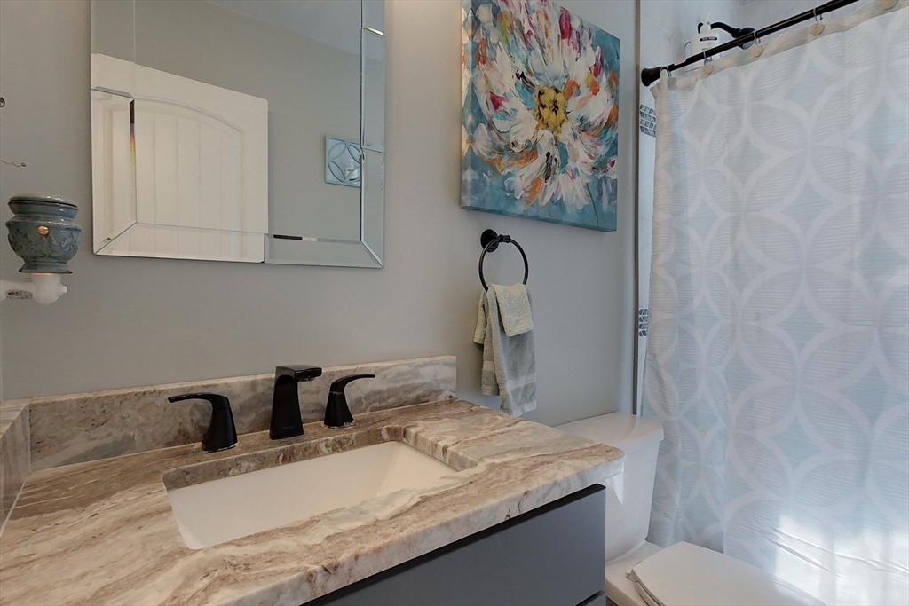45 Secret Lake Road Phillipston, MA 01331 - Photo 23 of 42 a bathroom with a granite countertop sink vanity mirror and toilet