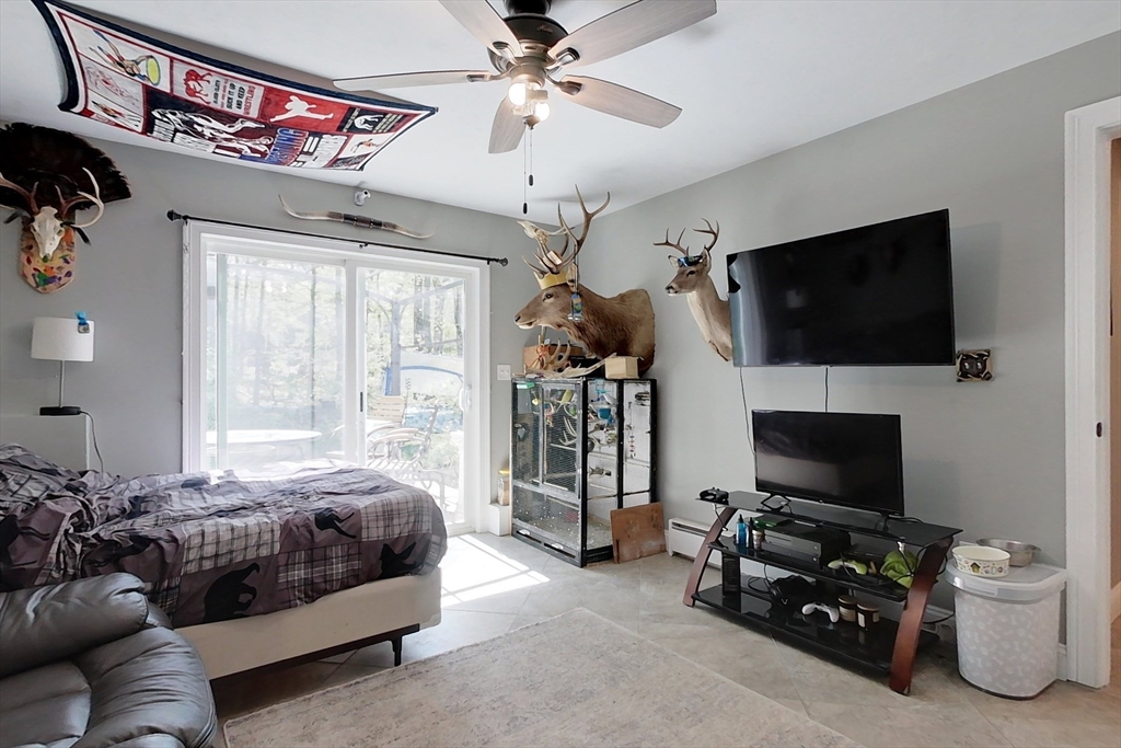 45 Secret Lake Road Phillipston, MA 01331 - Photo 27 of 42 a bedroom with a bed and a flat screen tv