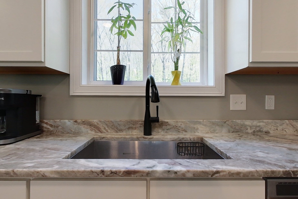 45 Secret Lake Road Phillipston, MA 01331 - Photo 3 of 42 a kitchen with granite countertop a sink and a window