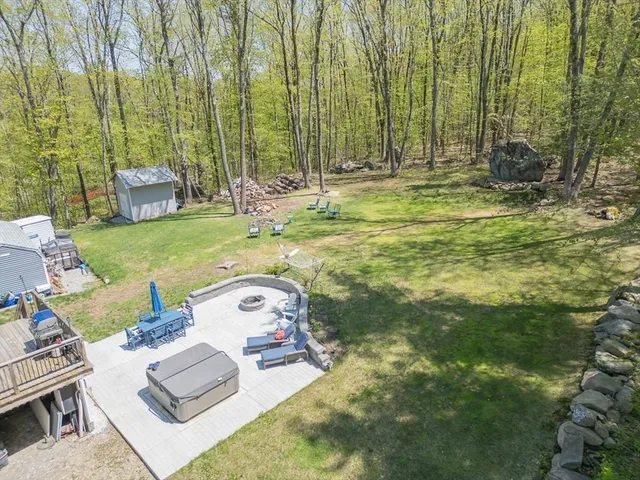 a view of a backyard with sitting area