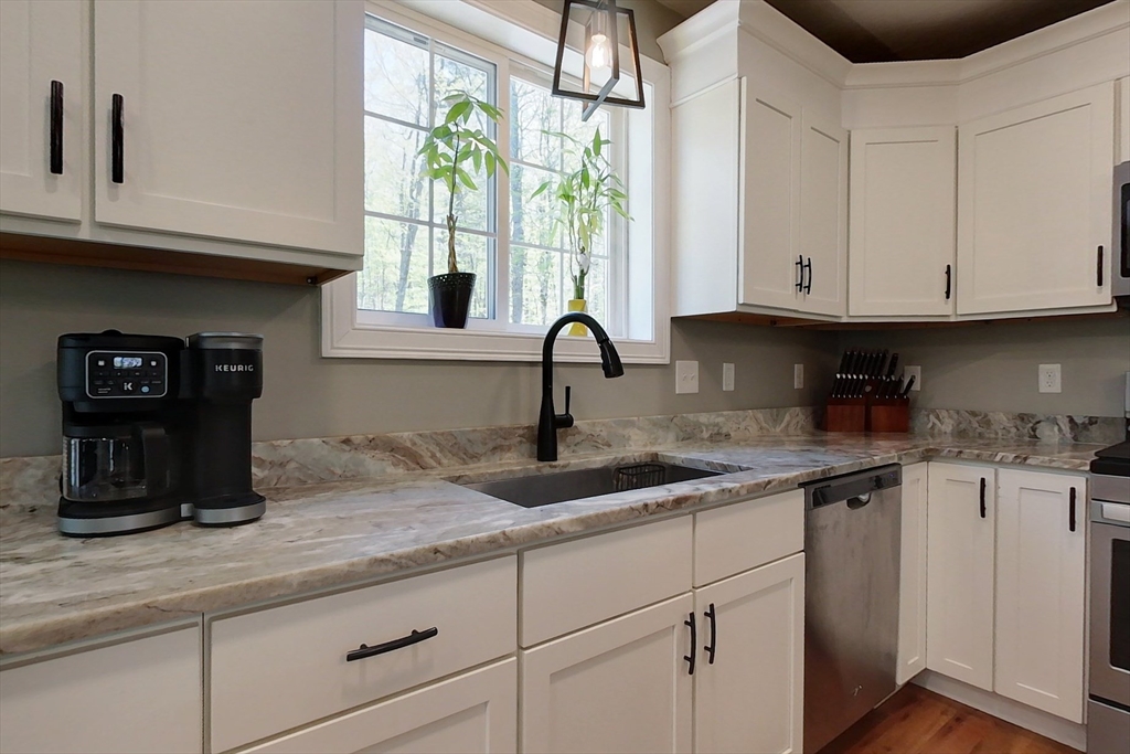 45 Secret Lake Road Phillipston, MA 01331 - Photo 4 of 42 a kitchen with stainless steel appliances granite countertop a sink window and cabinets