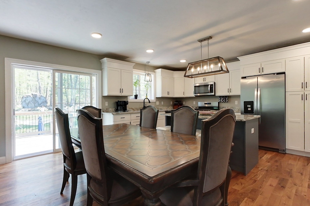 45 Secret Lake Road Phillipston, MA 01331 - Photo 8 of 42 a view of a dining room with furniture a chandelier and wooden floor