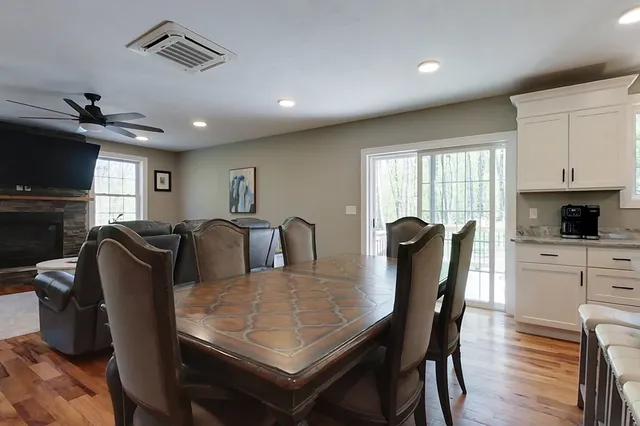 a view of a a dining room with furniture window and wooden floor