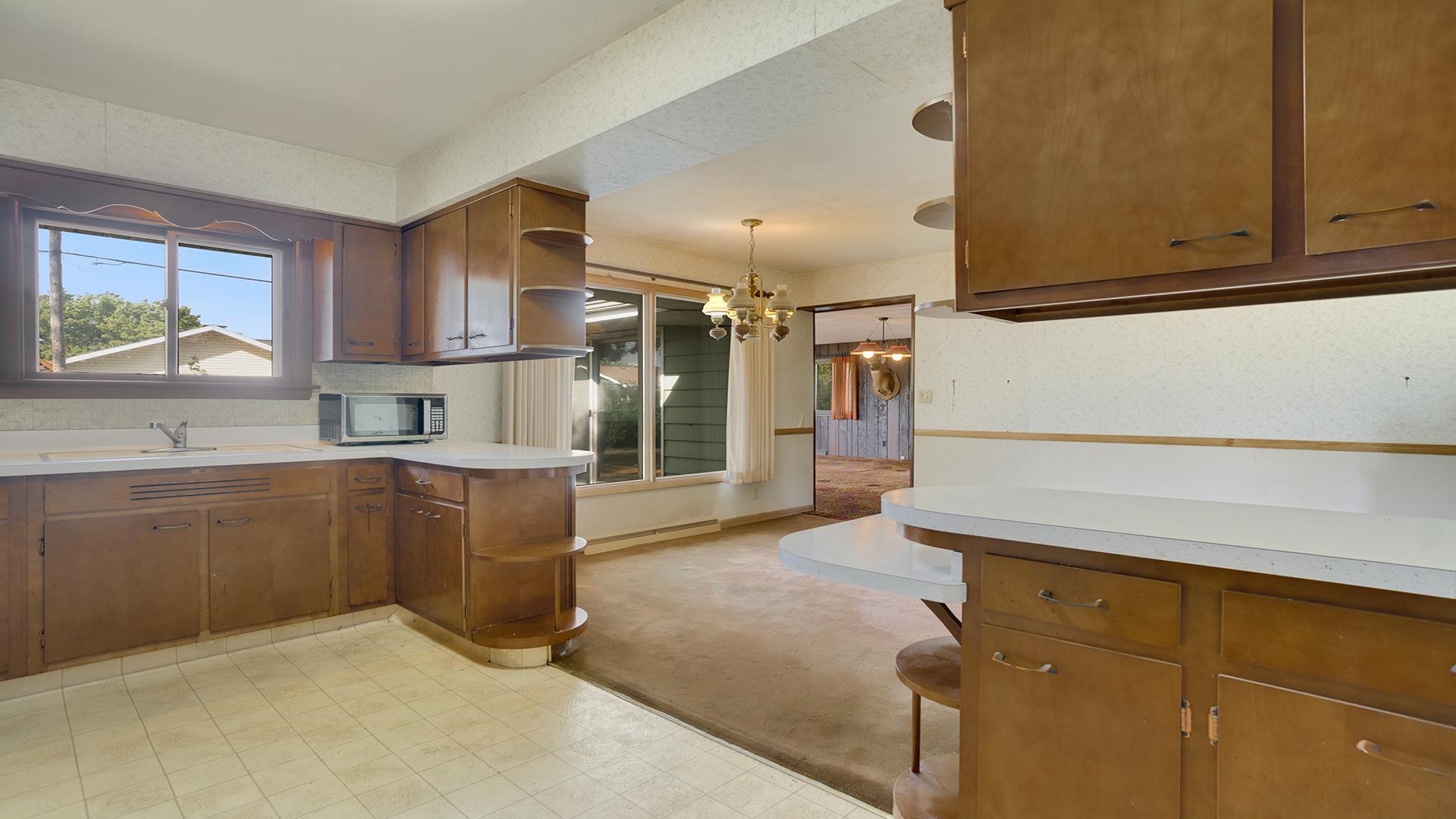 823 East Lilac Road Beloit, WI 53511 - Photo 12 of 28 a kitchen with granite countertop white cabinets and stainless steel appliances