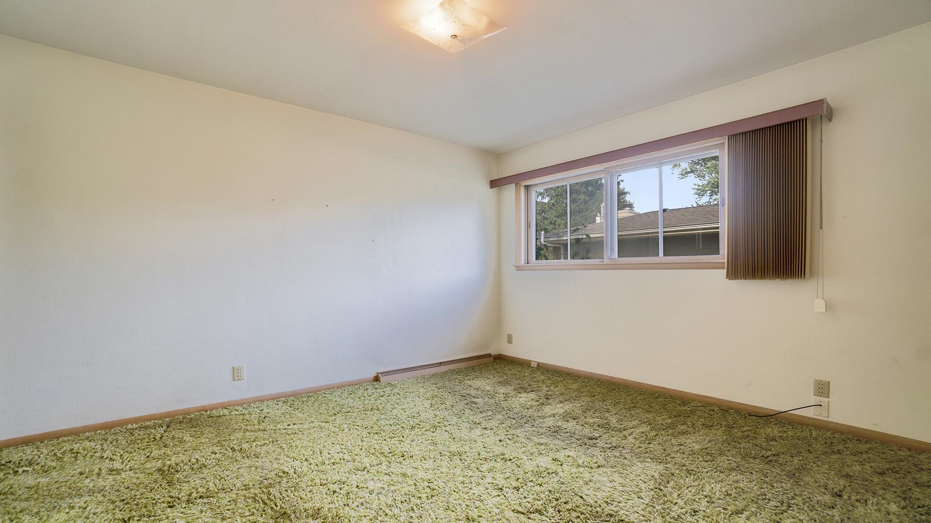823 East Lilac Road Beloit, WI 53511 - Photo 17 of 28 a view of an empty room with wooden floor and a window