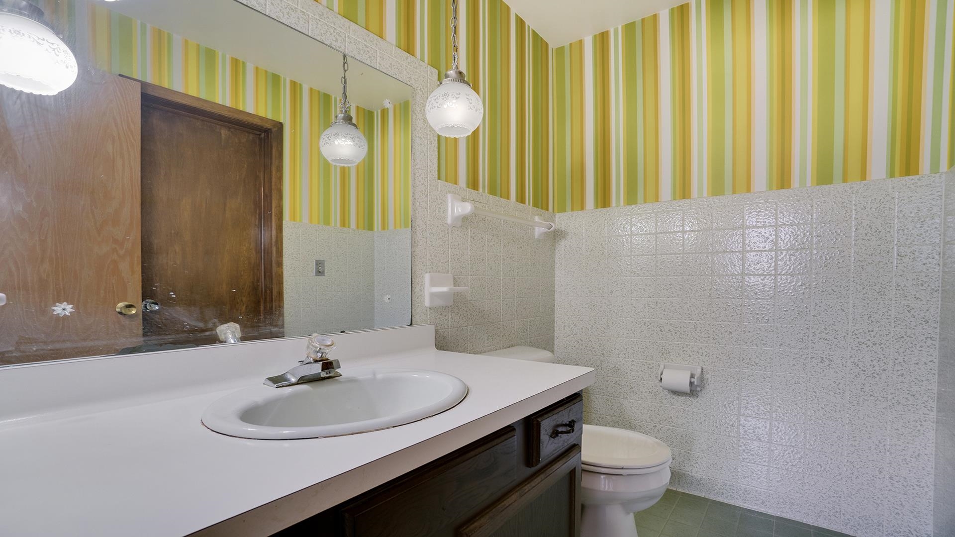 823 East Lilac Road Beloit, WI 53511 - Photo 18 of 28 a bathroom with a sink a toilet and mirror