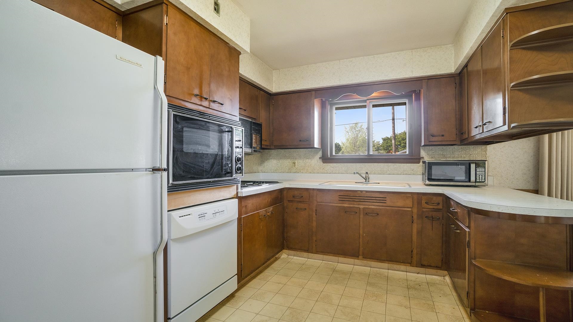 823 East Lilac Road Beloit, WI 53511 - Photo 10 of 28 a kitchen with stainless steel appliances granite countertop a sink and a stove