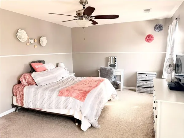 a bedroom with a bed and cabinets